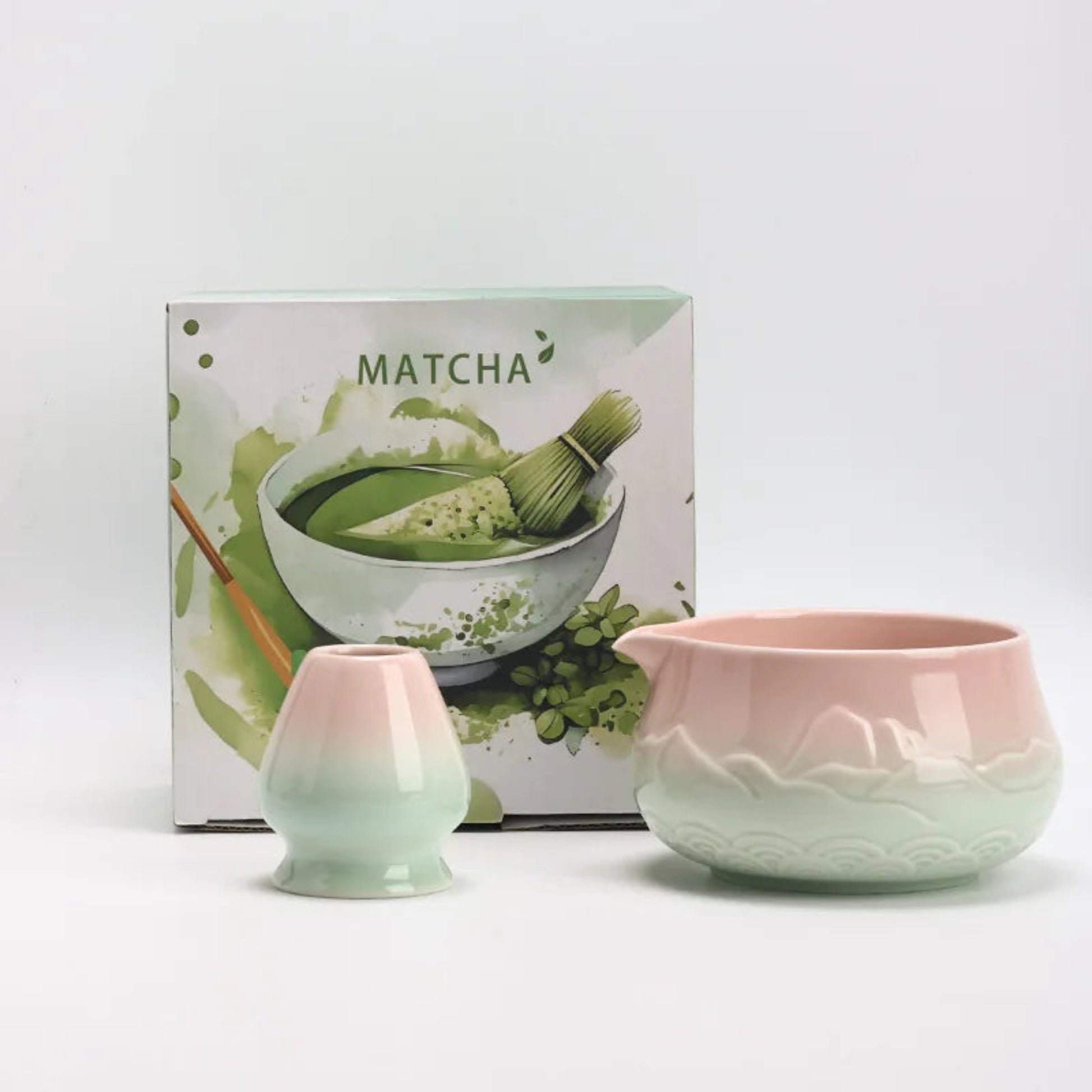 Matcha green tea set with two ceramic cups and a box labeled 'Matcha' on a white background.