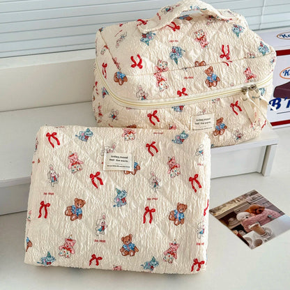 Two patterned bags with teddy bear and bow design on a white surface.