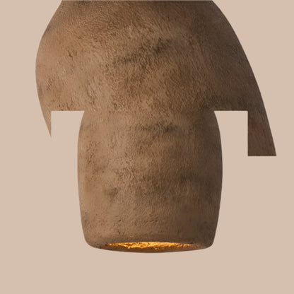 Textured wall sconce with a warm glow on a neutral background