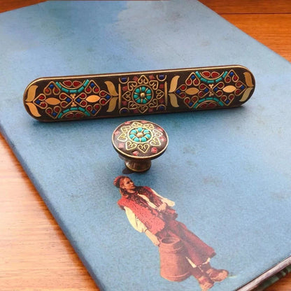 Decorative object with intricate patterns on a blue surface with an illustration of a person.