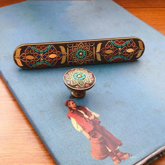 Decorative object with intricate patterns on a blue surface with an illustration of a person.