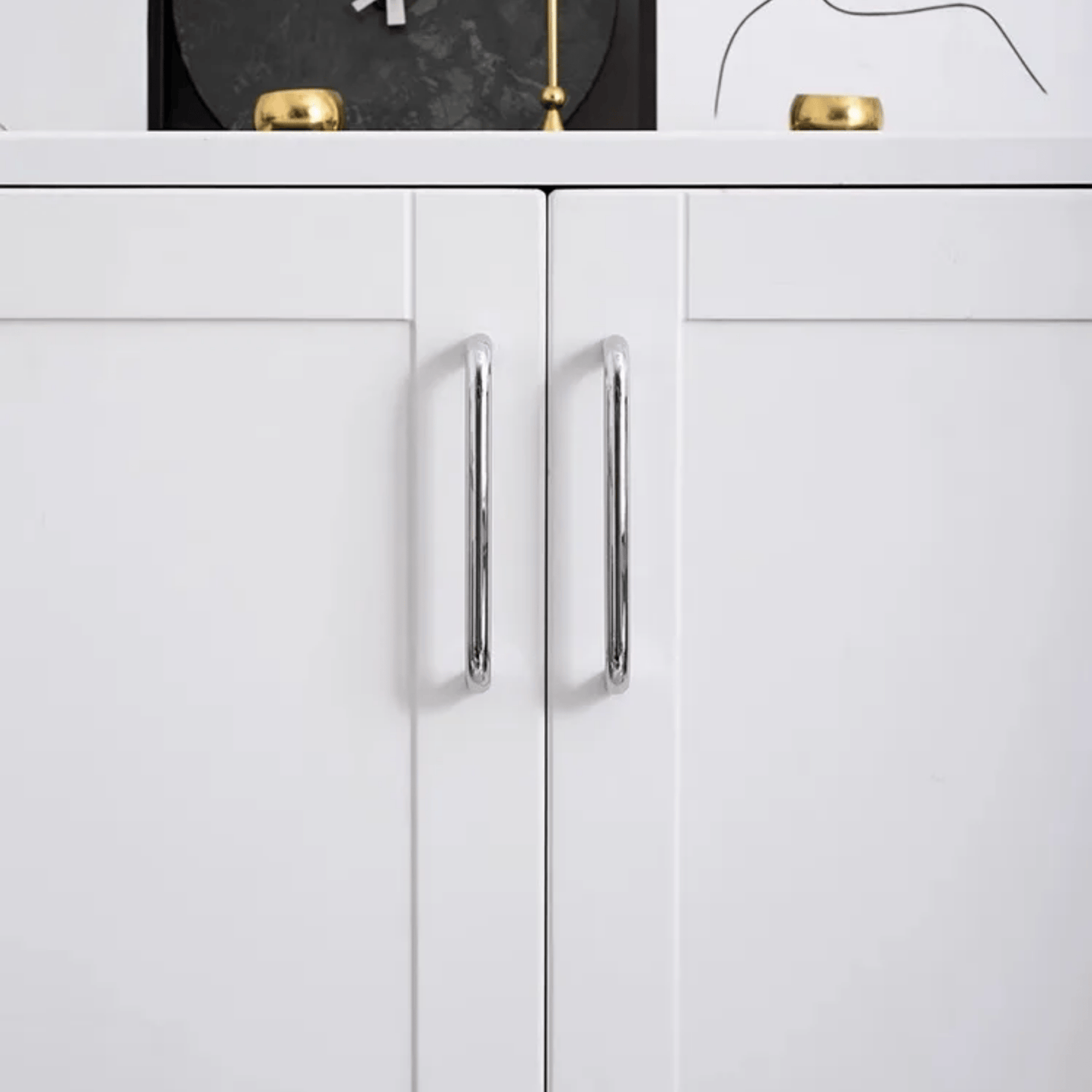 White cabinet with silver handles on a white background