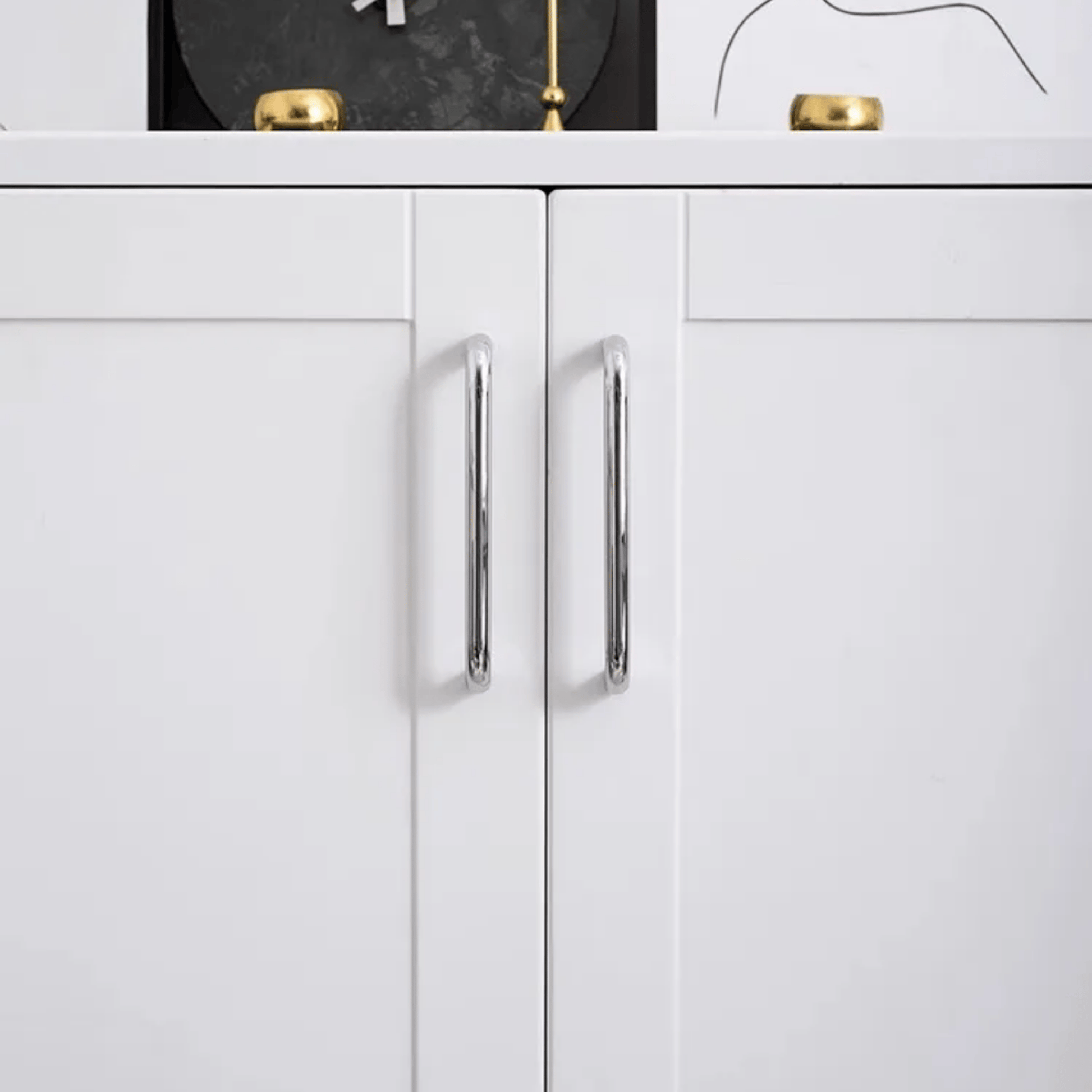 White cabinet with silver handles on a white background