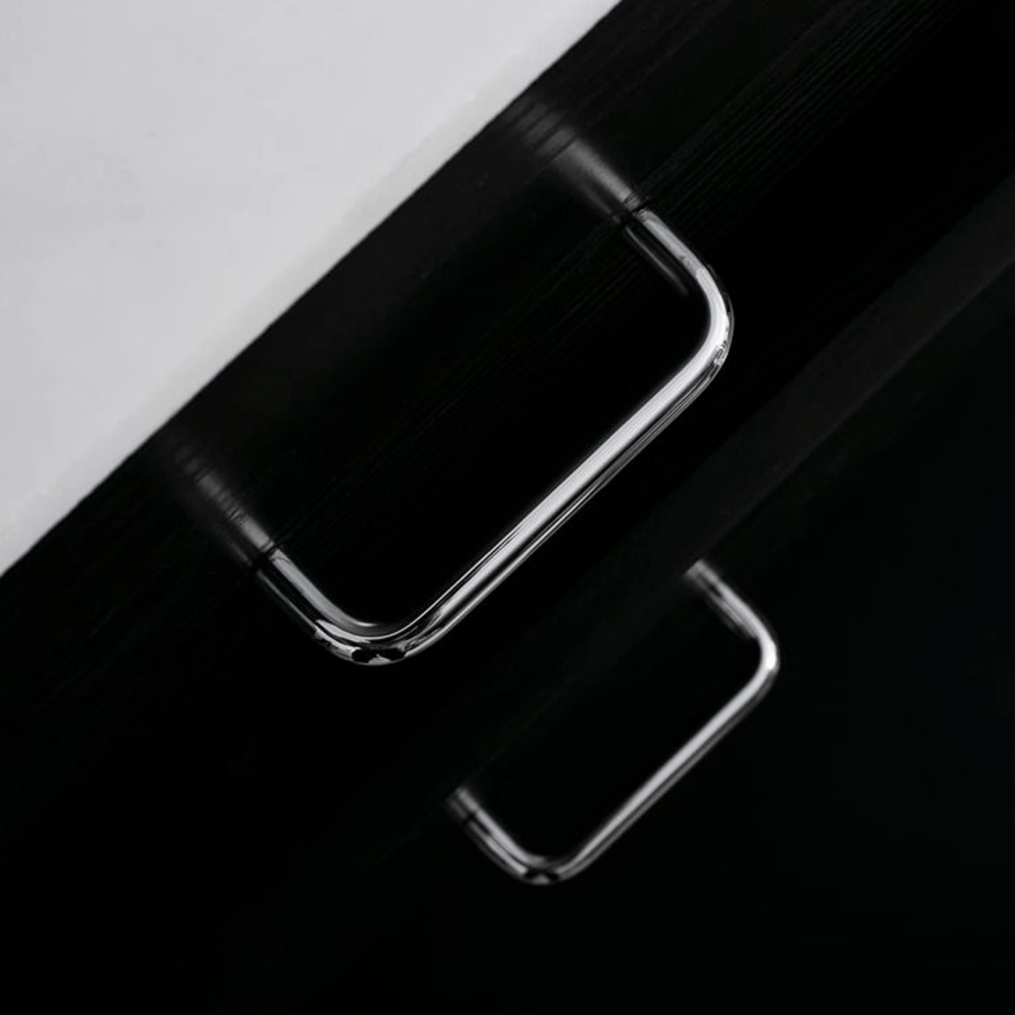 Close-up of a smartphone with a reflective surface on a black and white background