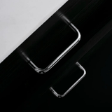 Close-up of a smartphone with a reflective surface on a black and white background