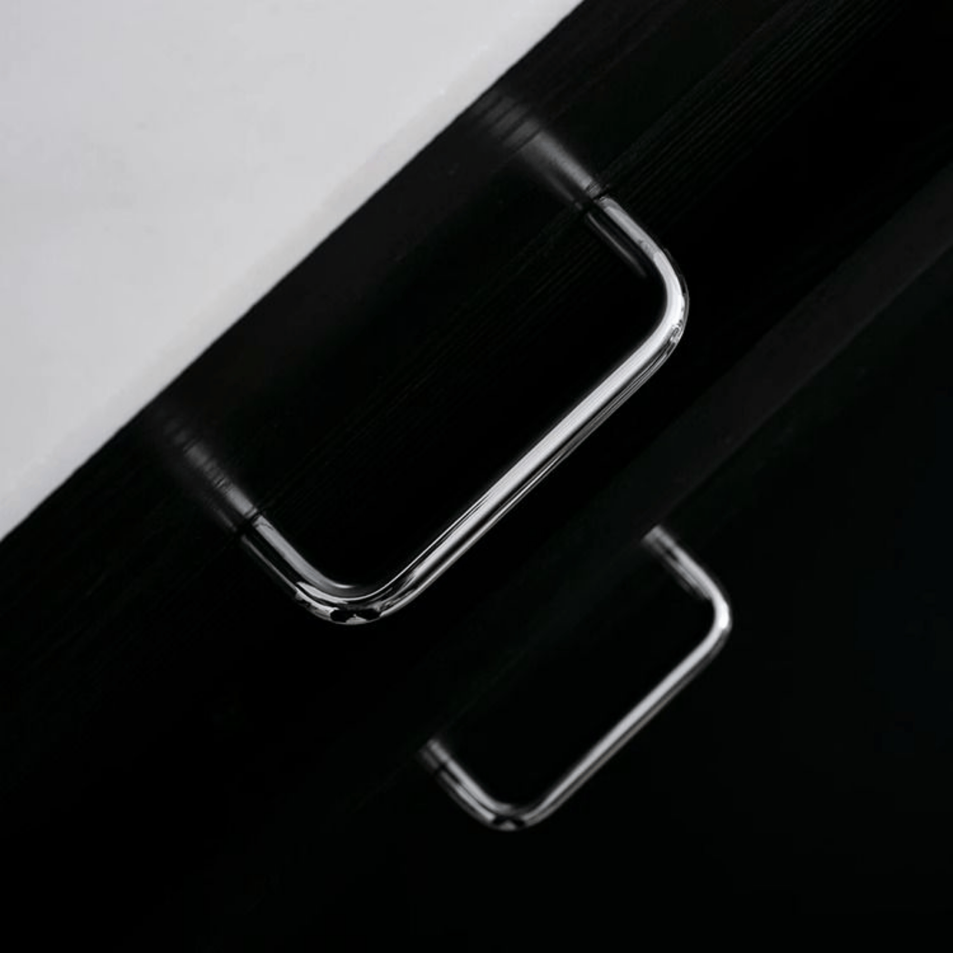 Close-up of a smartphone with a reflective surface on a black and white background