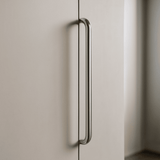 Metallic handle on a light-colored cabinet door