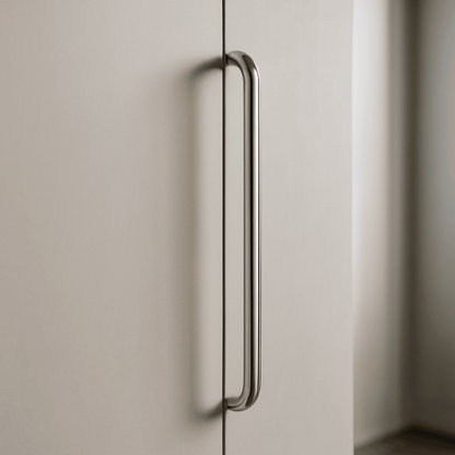 Metallic handle on a light-colored cabinet door