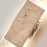 Rectangular stone block with a textured surface on a light background