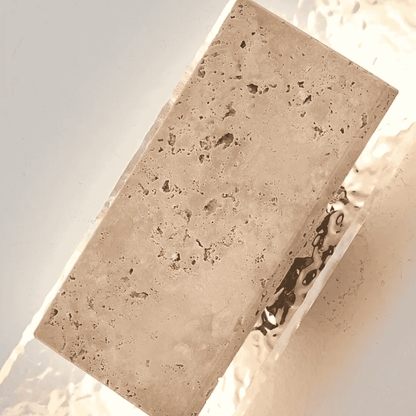 Rectangular stone block with a textured surface on a light background