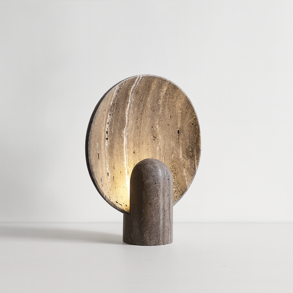 Cylindrical lamp with a round, textured shade on a light gray background