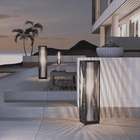 Modern outdoor setting with decorative lamps and a building in the background