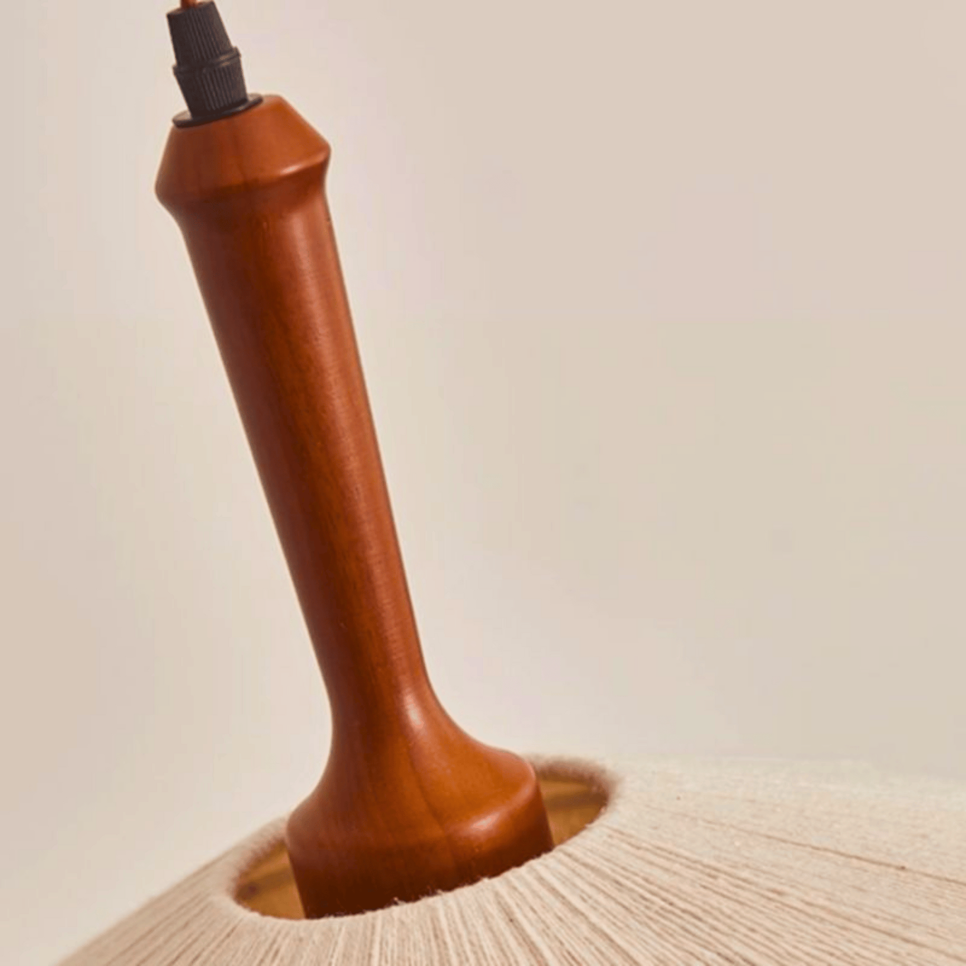 Wooden lamp base on a neutral background