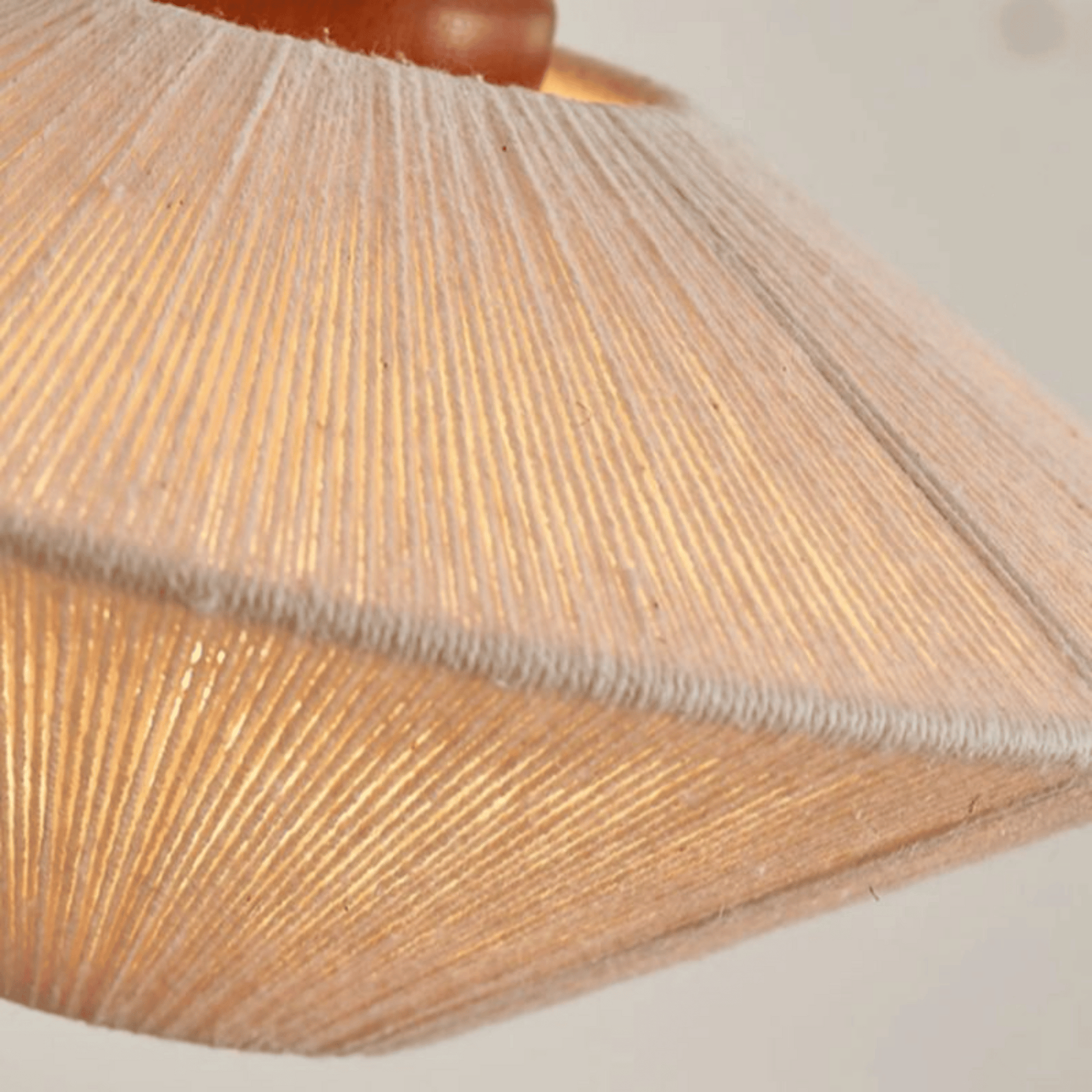 Close-up of a textured lampshade with a wooden base.