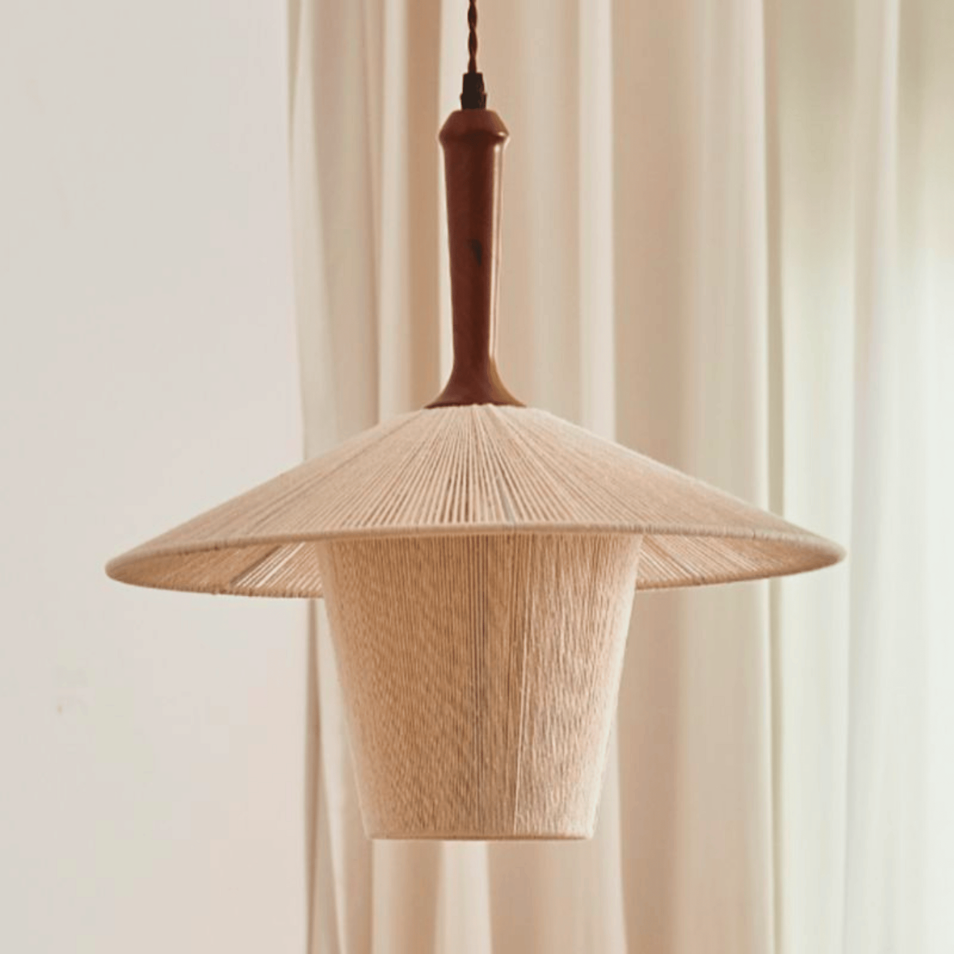 Wooden pendant lamp with a natural finish against a neutral background