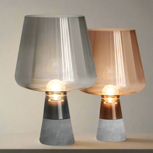Two table lamps with metallic shades and concrete bases on a white background, 