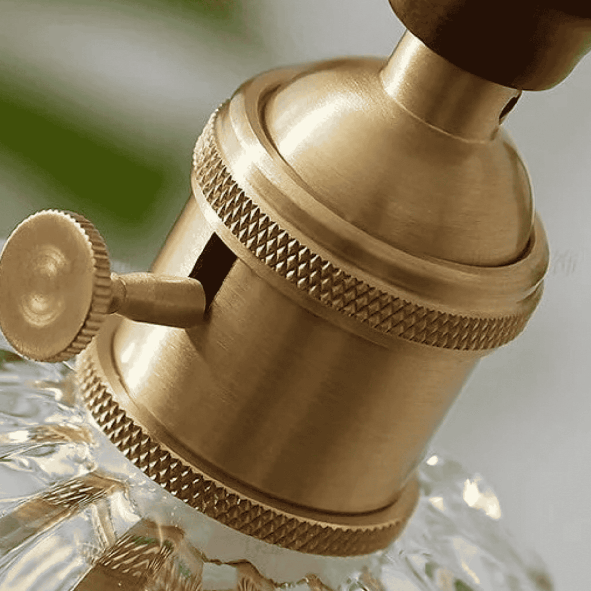 Close-up of a gold-colored faucet handle on a blurred background