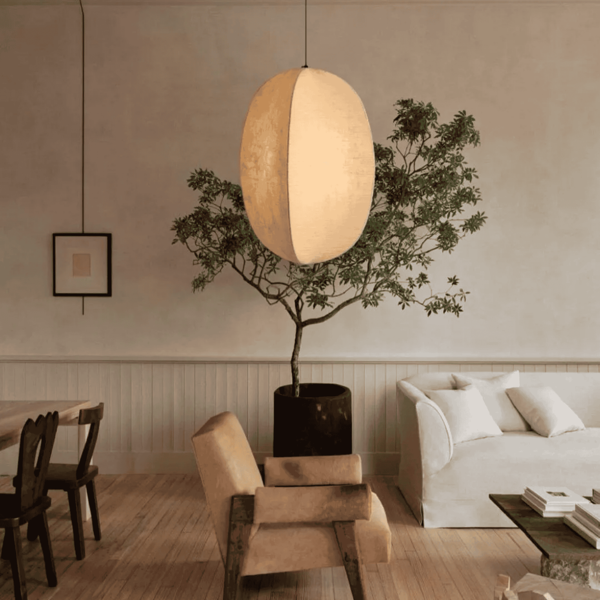 Modern living room with a pendant light, potted plant, and sofa.