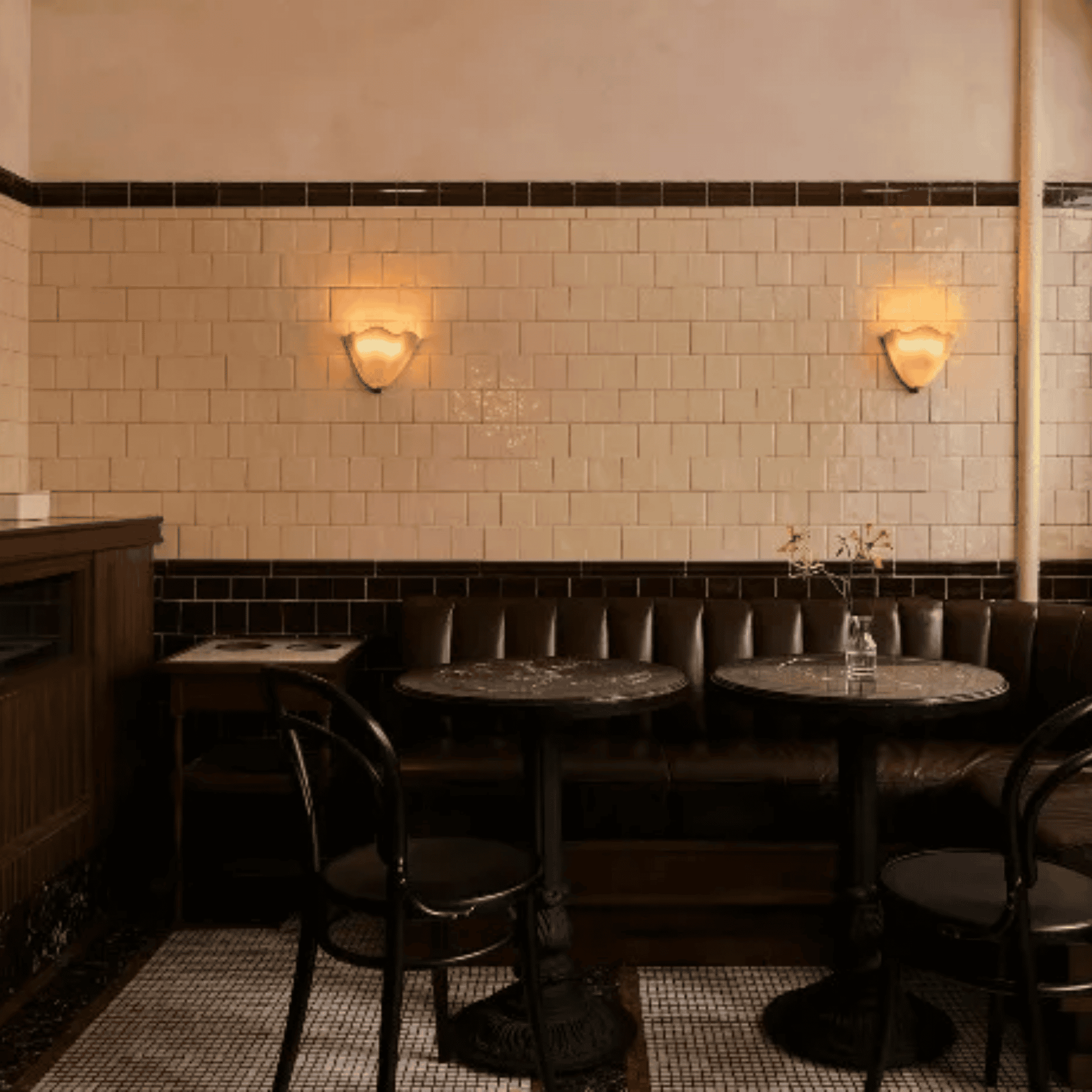 Dining area with tiled walls, tables, and chairs in a cozy setting.