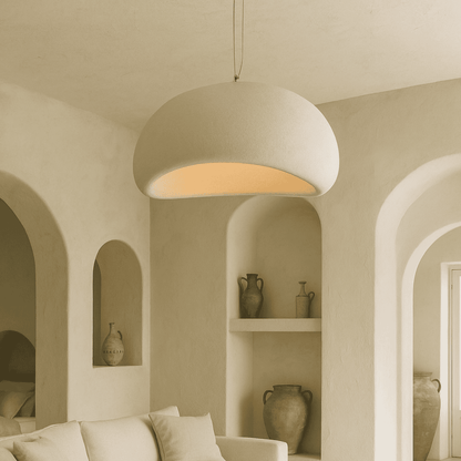 Beige pendant light hanging in a room with arched walls and shelves.