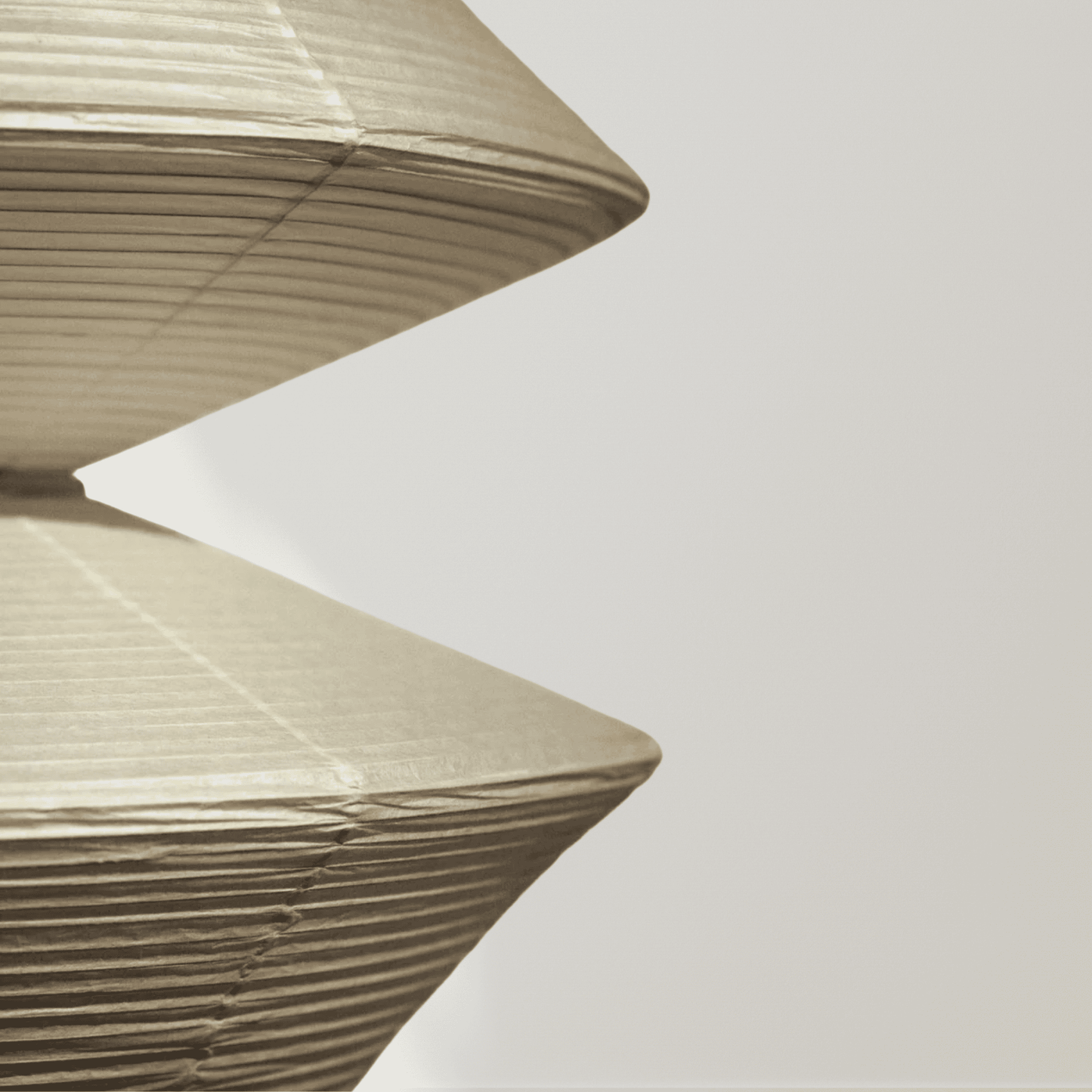 Close-up of a textured beige lampshade against a light gray background