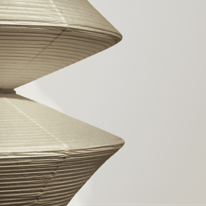 Close-up of a textured beige lampshade against a light gray background