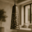 Decorative pendant light with a unique pattern in a blurred indoor setting