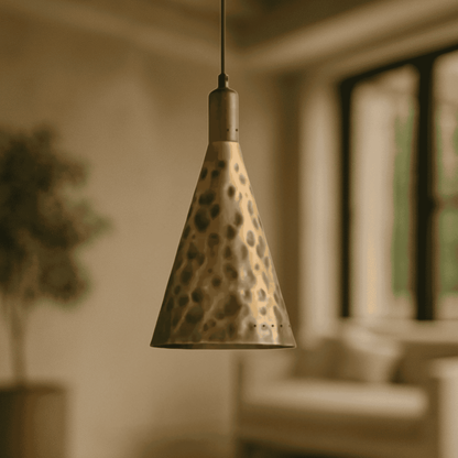 Conical pendant light with a spotted pattern hanging in a softly blurred room.