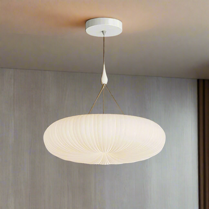Pendant light fixture with white lampshade on a gray background