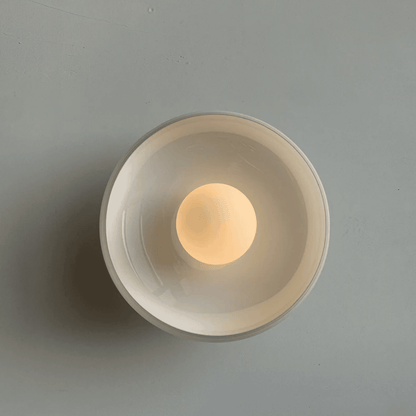 Round wall light fixture on a gray background