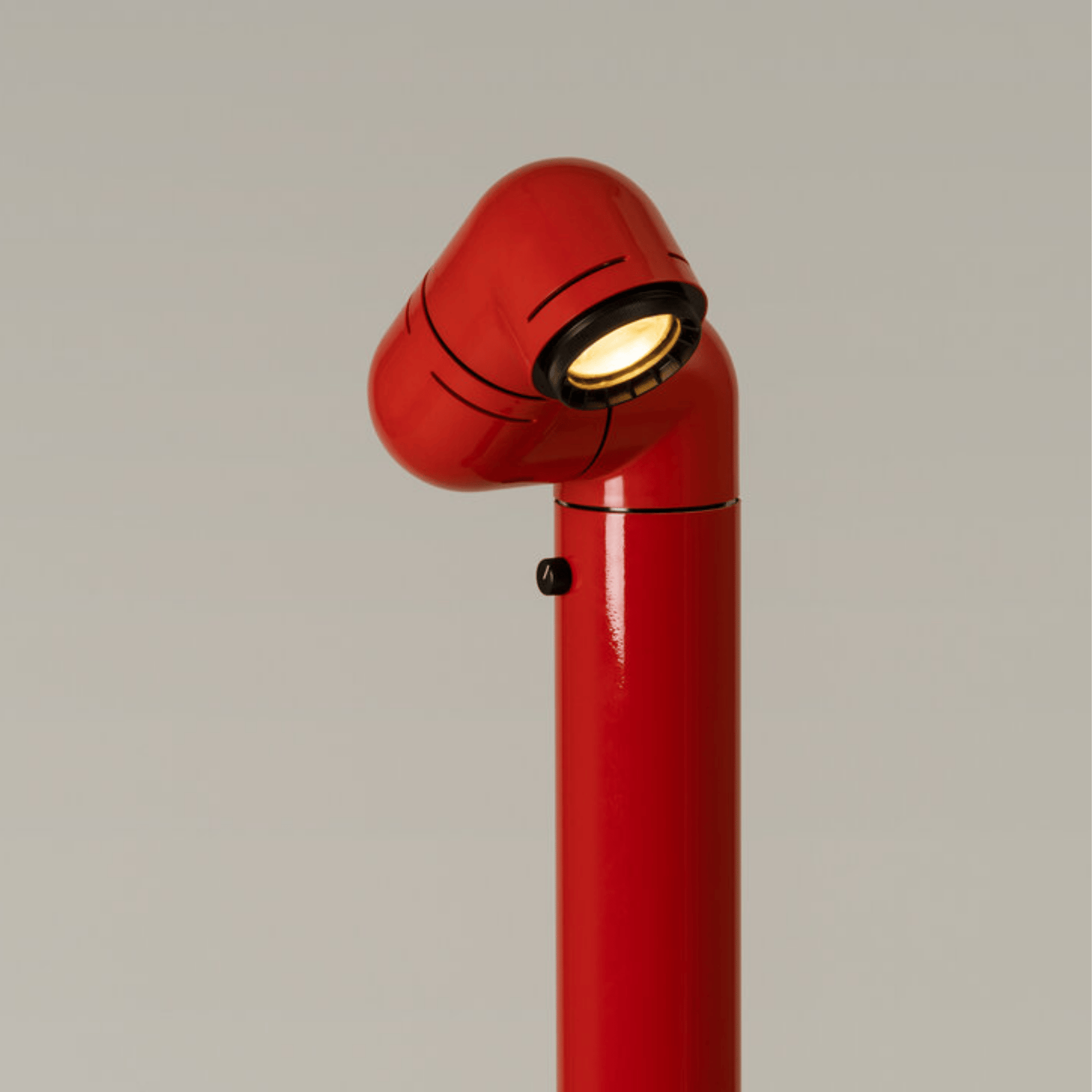 Red lamp with a unique design on a plain background