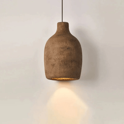 Brown pendant light hanging against a plain background
