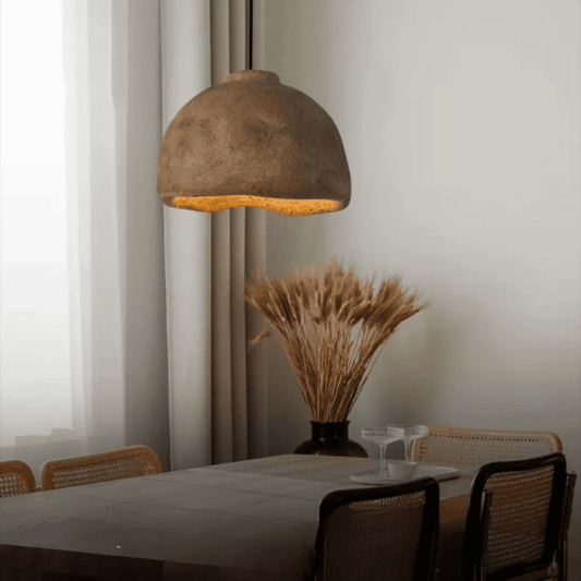 Dining room with a textured pendant light, table, and chairs.