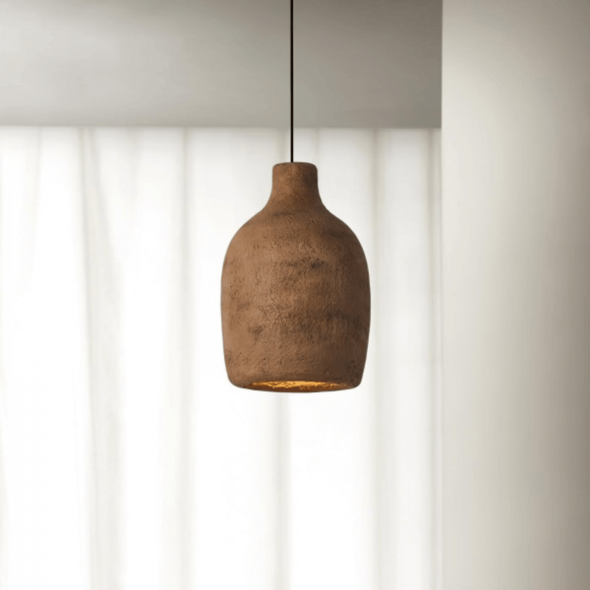 Brown pendant light hanging against a neutral background