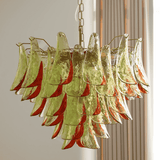 Chandelier with green and red glass panels on a neutral background