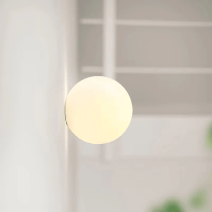 Round light fixture on a white ceiling with a blurred background