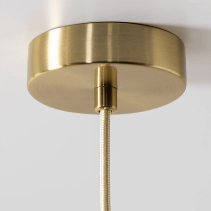Close-up of a gold ceiling light fixture on a white background