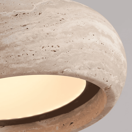 Close-up of a stone-like surface with a light interior on a gray background