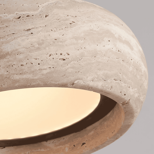 Close-up of a stone-like surface with a light interior on a gray background