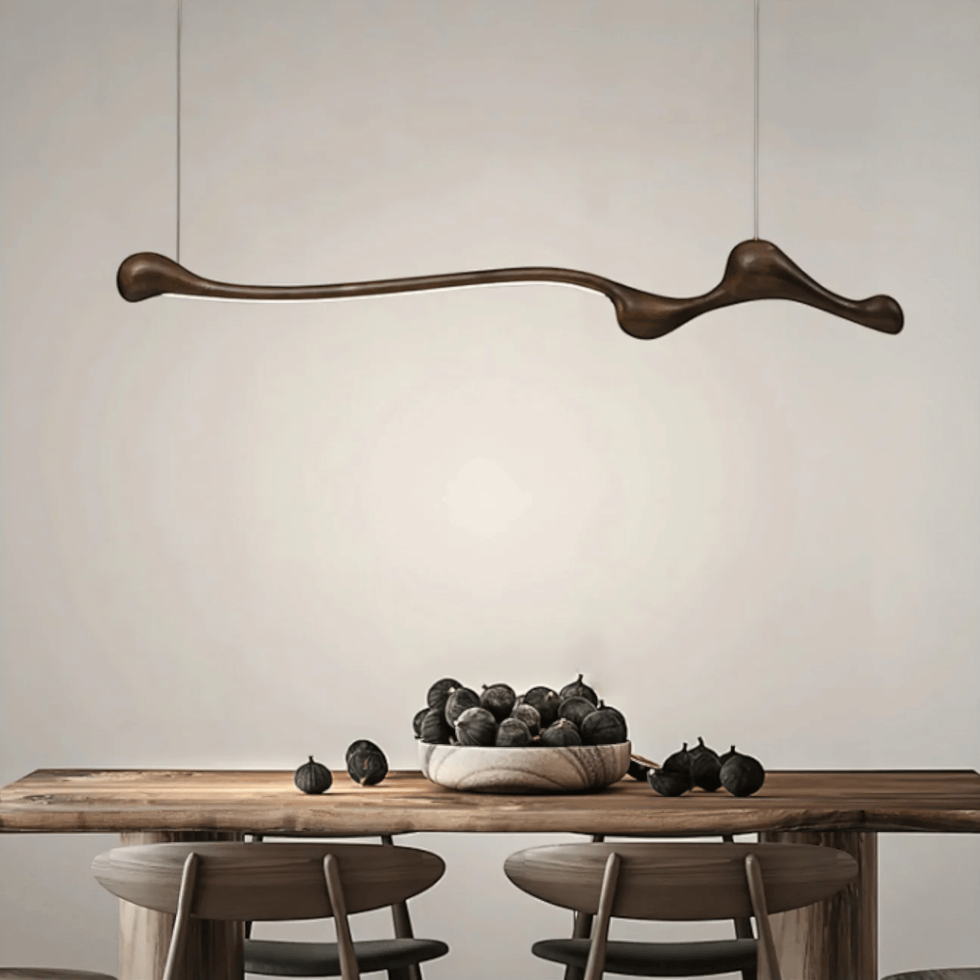 Modern dining room with a wooden table, chairs, and a decorative pendant light.