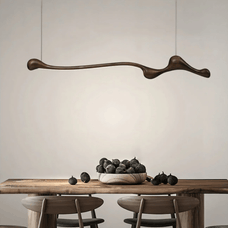 Modern dining room with a wooden table, chairs, and a decorative pendant light.