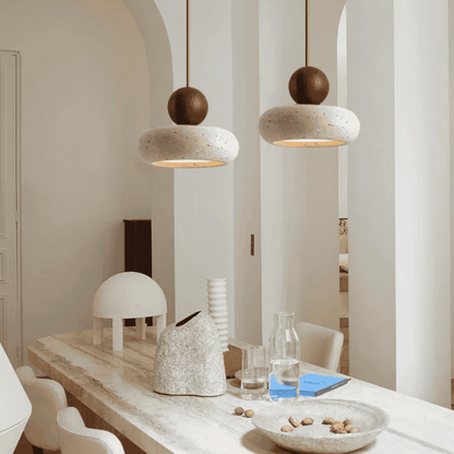 Modern interior with pendant lights, a dining table, and decorative items.
