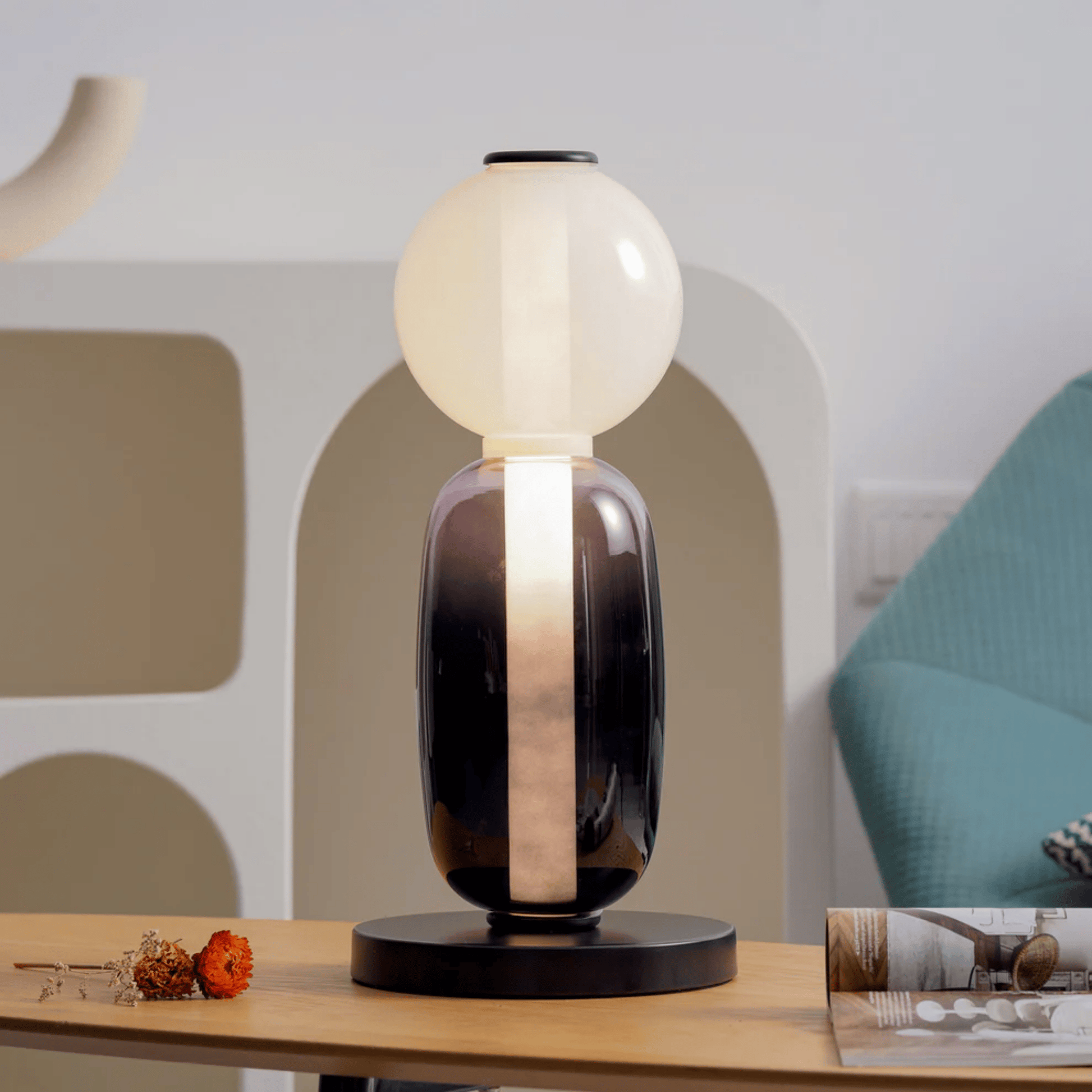 Modern table lamp with a black base and white shade on a wooden surface.