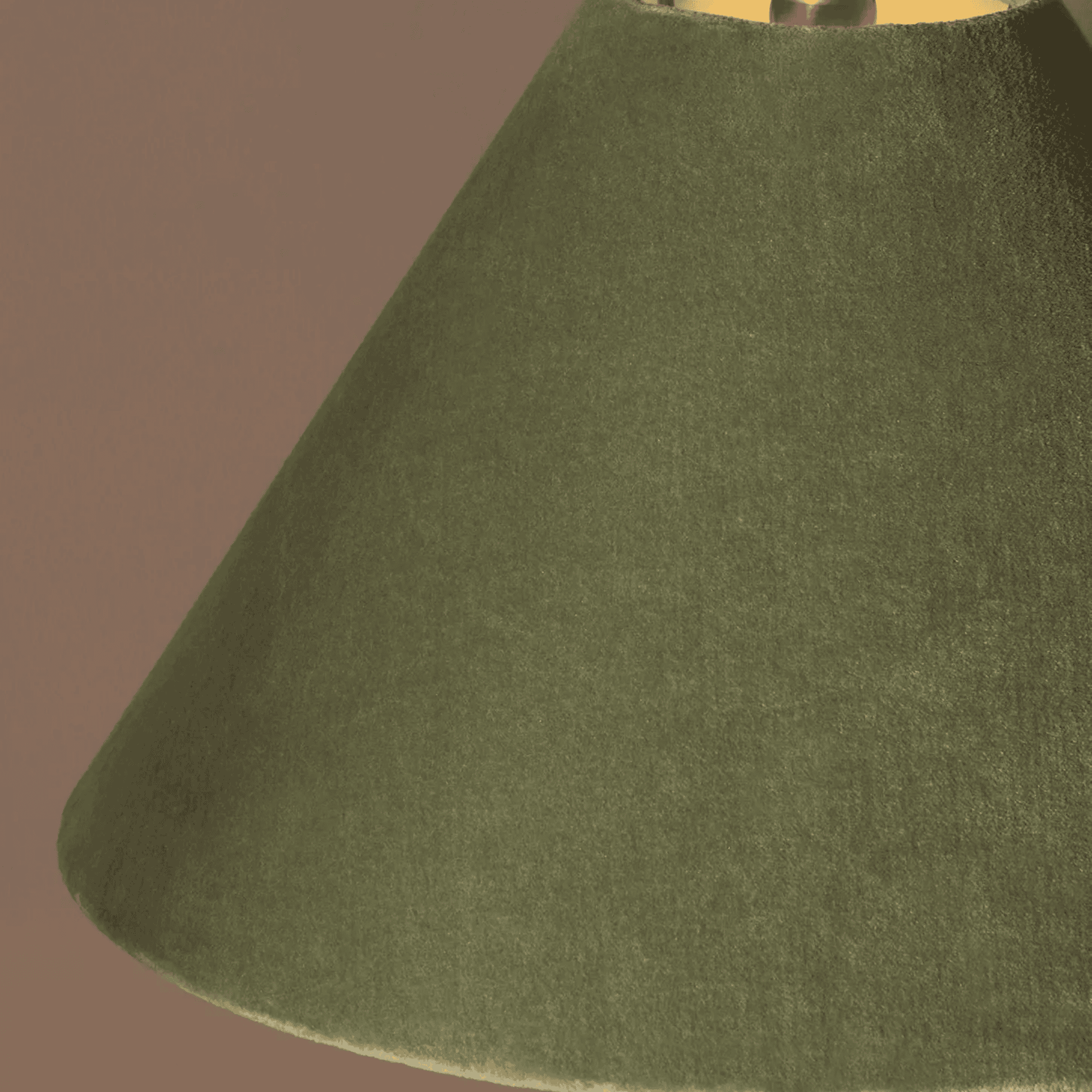 Close-up of a green lampshade against a brown background