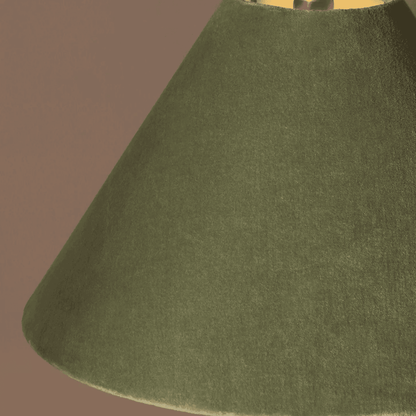 Close-up of a green lampshade against a brown background