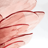 Close-up of pink and red abstract paint strokes on a light background