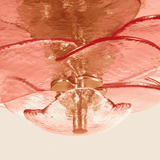 Close-up of a ceiling fan with metallic blades and light fixture.