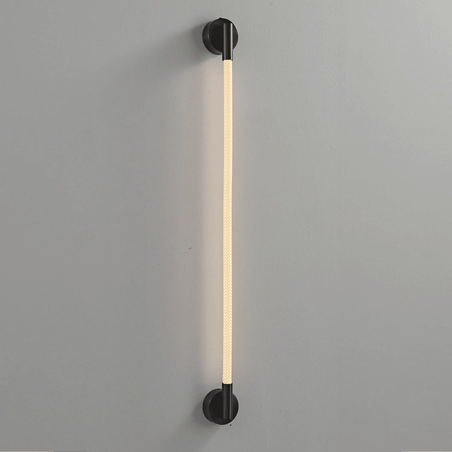 Modern wall-mounted light fixture on a gray background