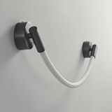 Black wall-mounted lamp with a flexible white hose on a gray background