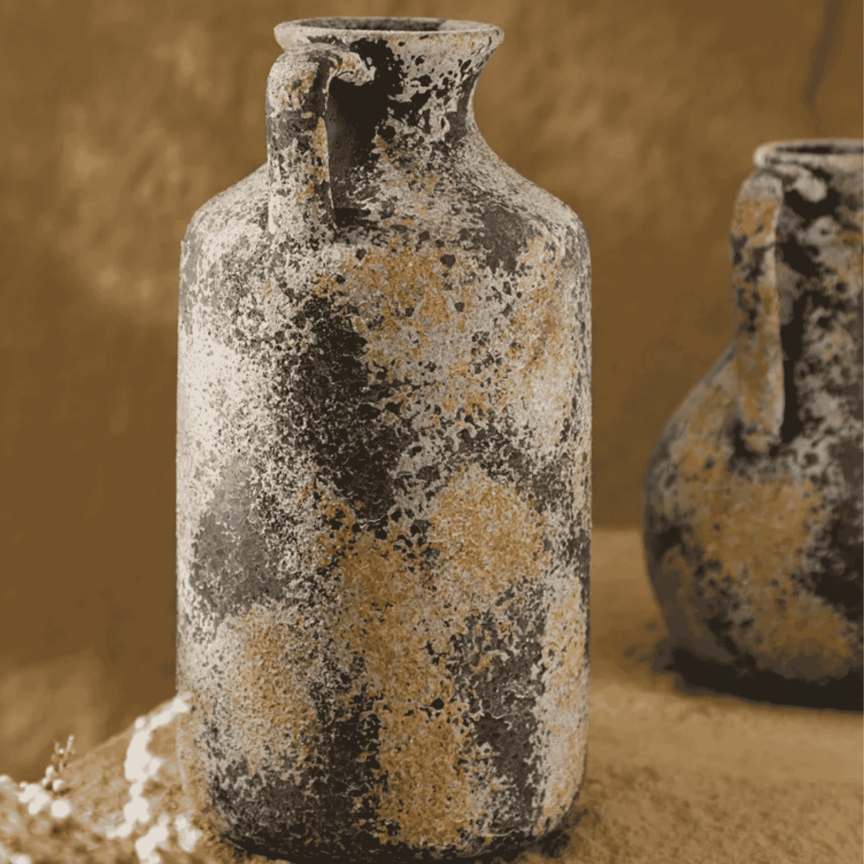 Two rustic ceramic vases with a textured surface on a beige background